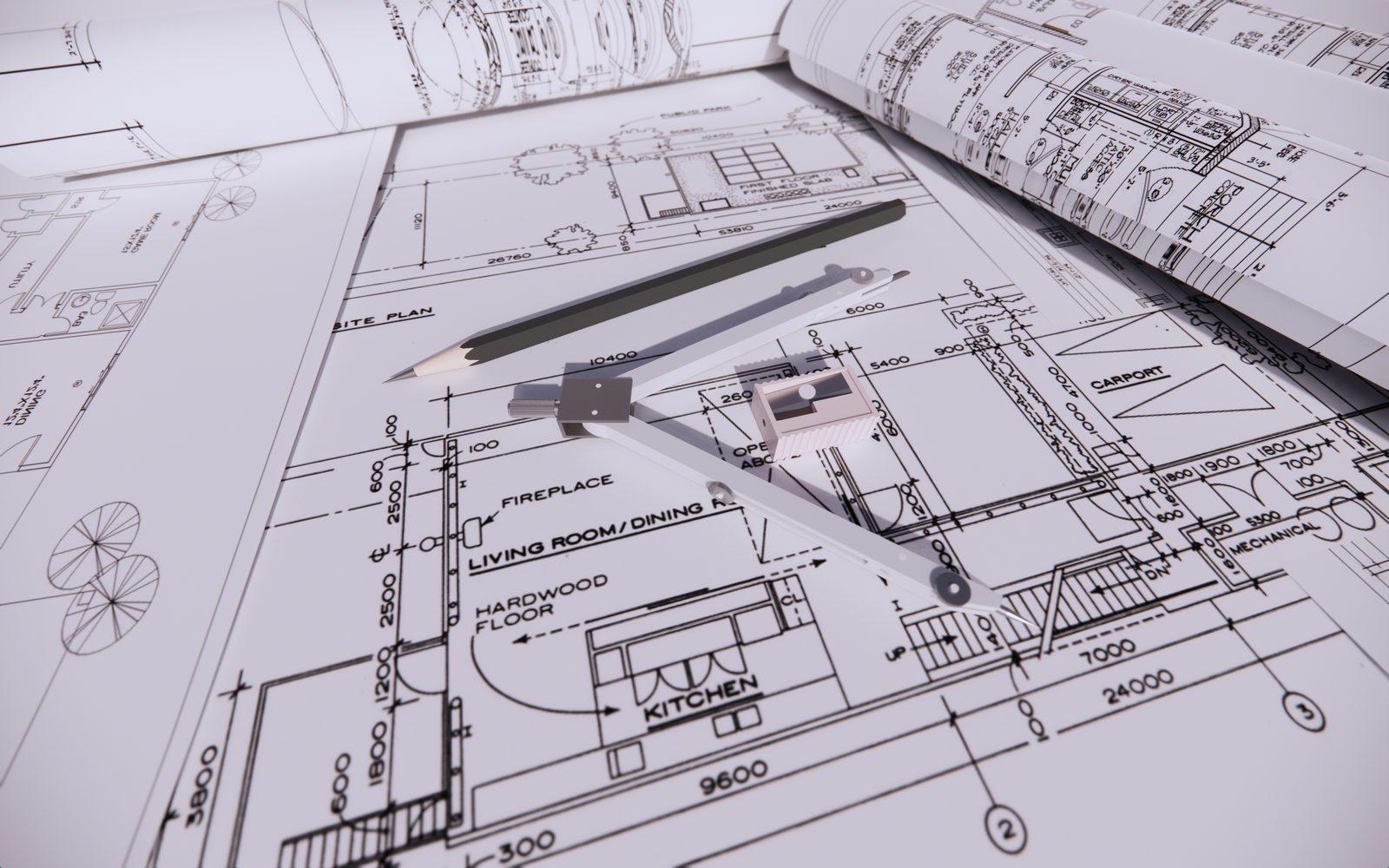 Rolled floor plan drawings with a drafting compass and pencil across a room layout sheet
